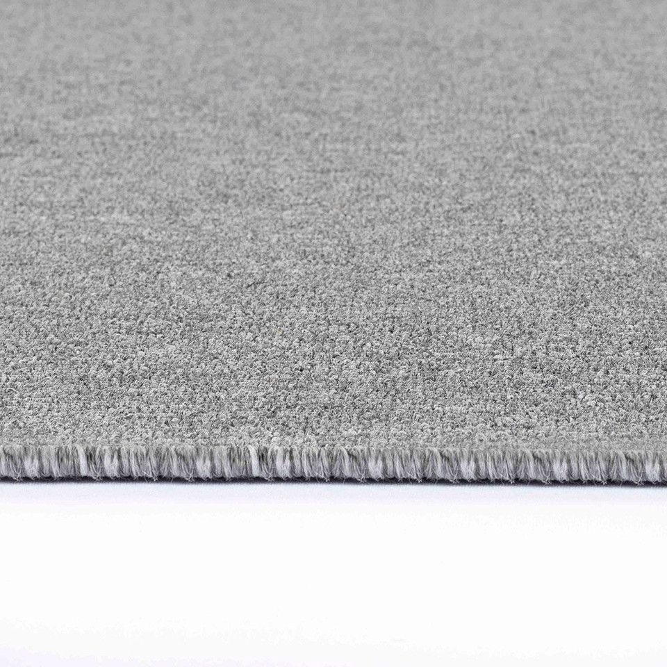 plain low pile silver rug closeup edge on white floor