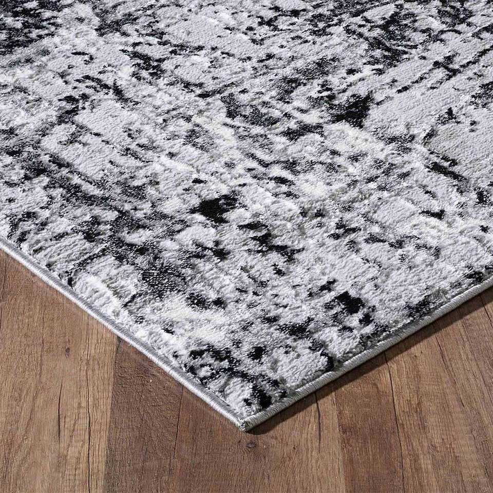 modern abstract abrasion black rug closeup corner on a wooden floor