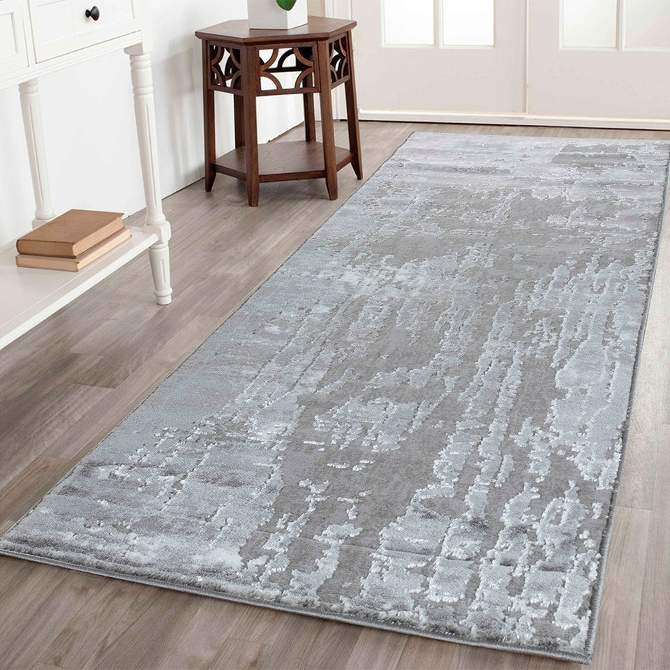 modern abstract abrasion grey rug runner in a hallway
