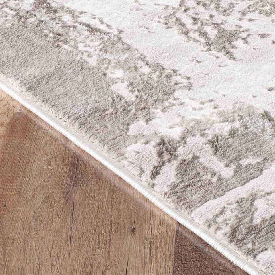 modern abstract abrasion stone rug runner closeup edge on a wooden floor