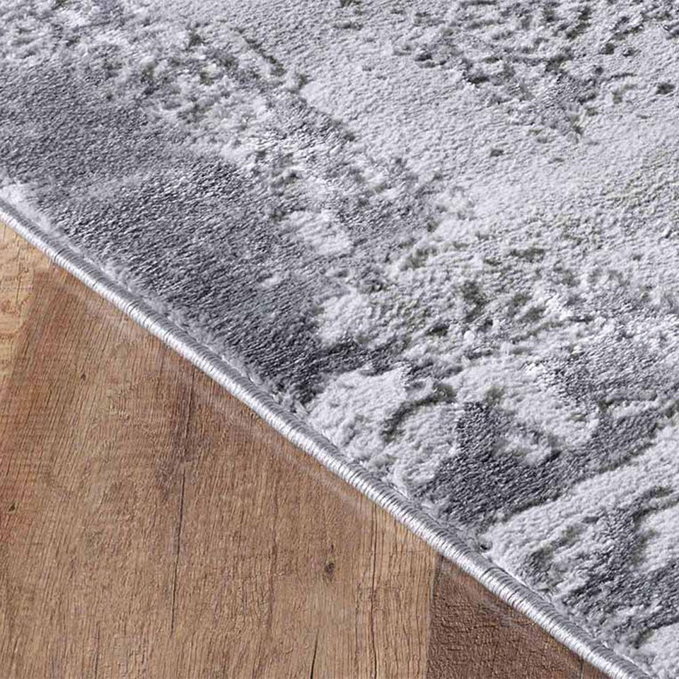 modern abstract acrylic grey rug runner closeup edge on wooden floor