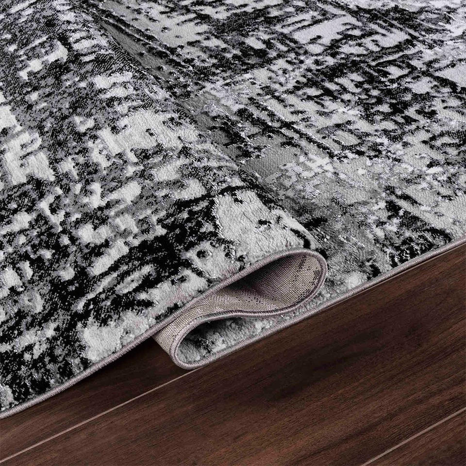 modern abstract lines black rug folded on wooden floor
