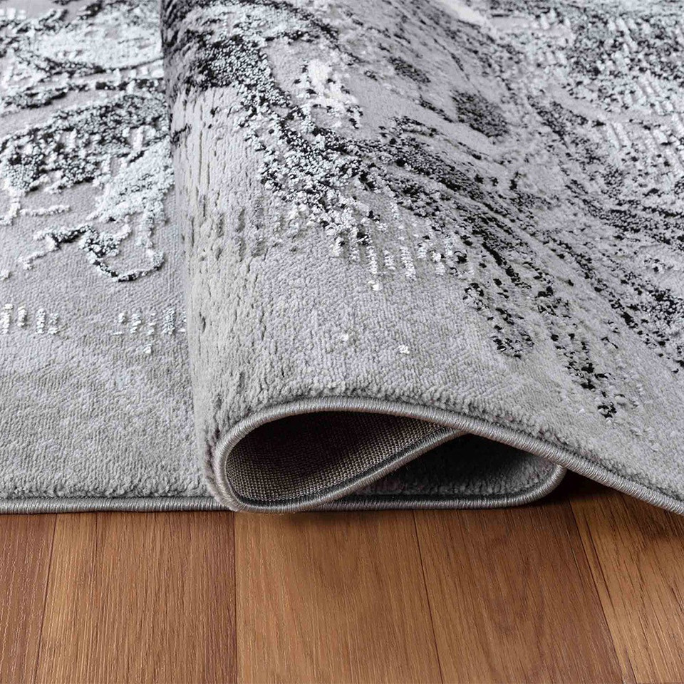 modern abstract water flow black rug runner folded on a wooden floor