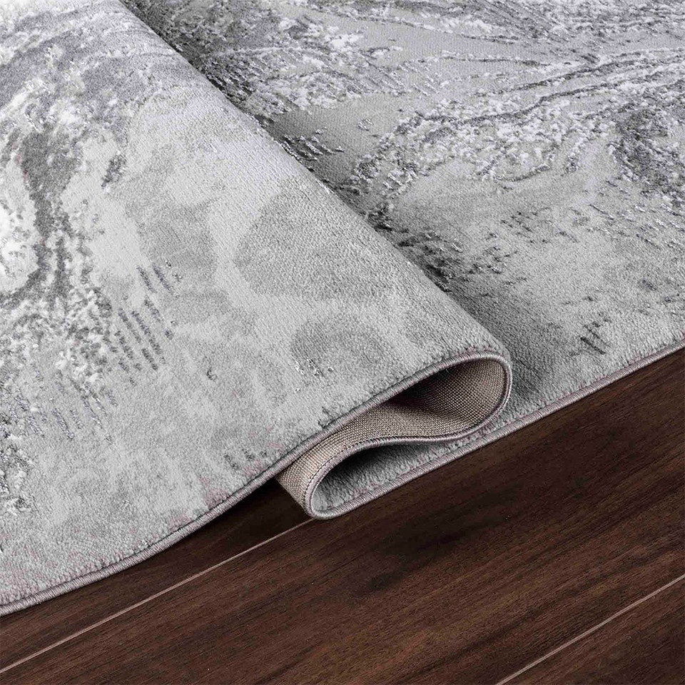 modern abstract water flow grey rug folded on wooden floor