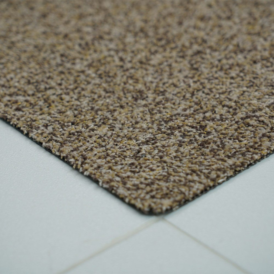 beige dirt trapper doormat closeup corner