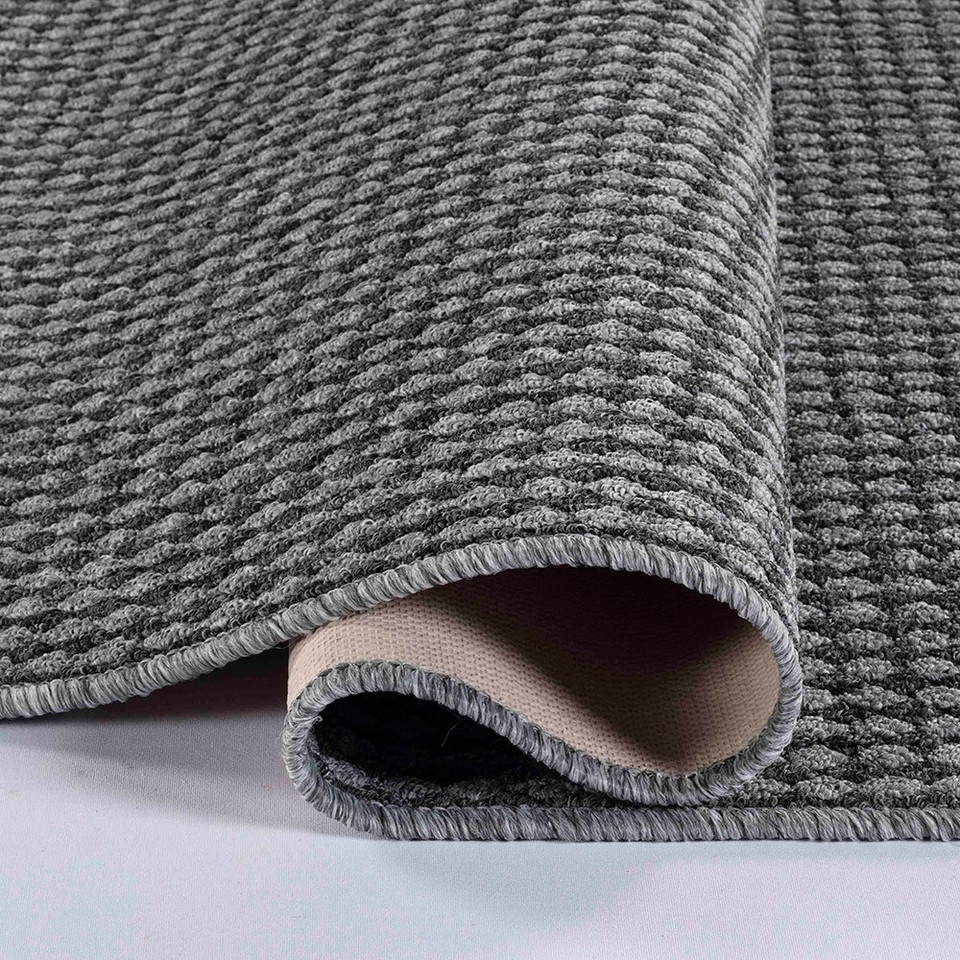 grey non-slip dirt trapper mat folded on white floor
