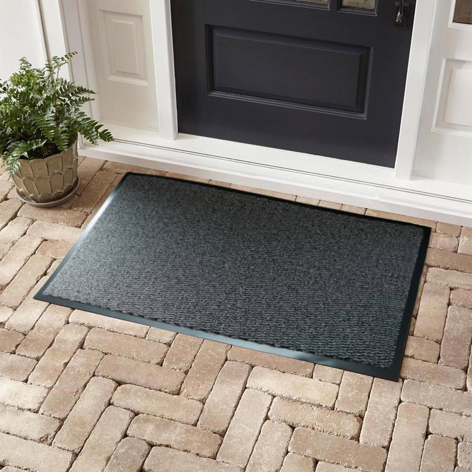 silver non-slip dirt trapper mat in front of a door outdoors