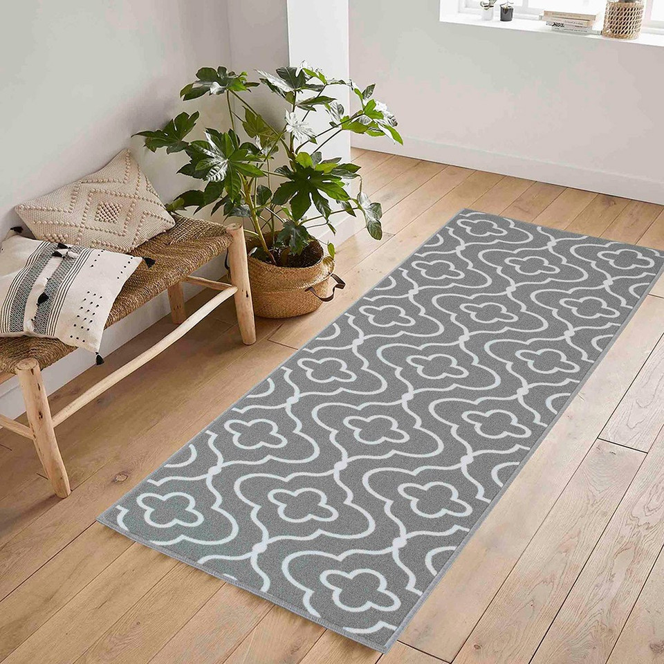 quatrefoil grey doormat runner in a hallway on a wood floor