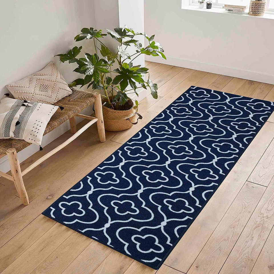 quatrefoil navy doormat runner in a hallway on a wood floor
