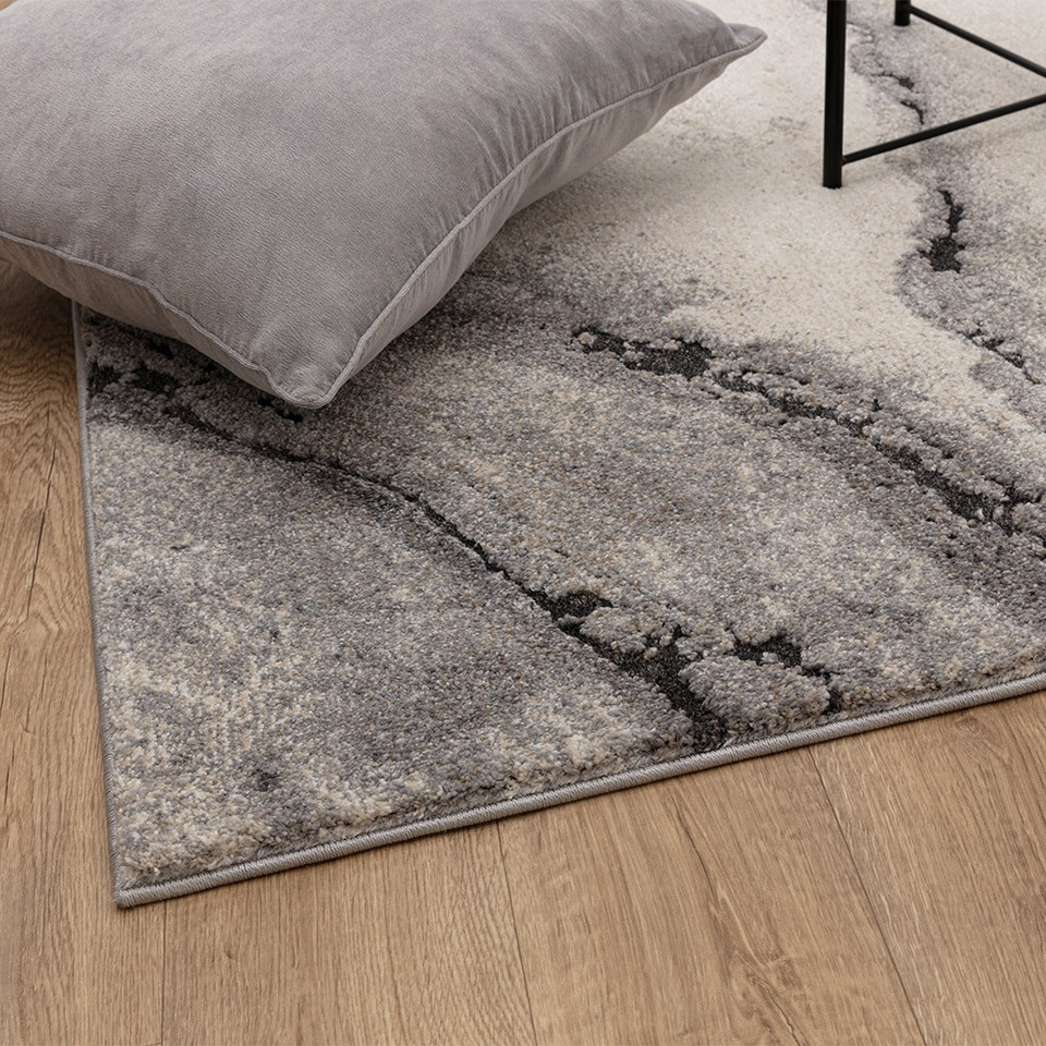 abstract grey shaggy rug side angle view with pillow and table legs