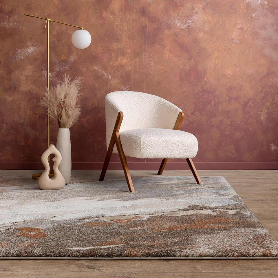 abstract terra shaggy rug in a living room with white chair and lamp