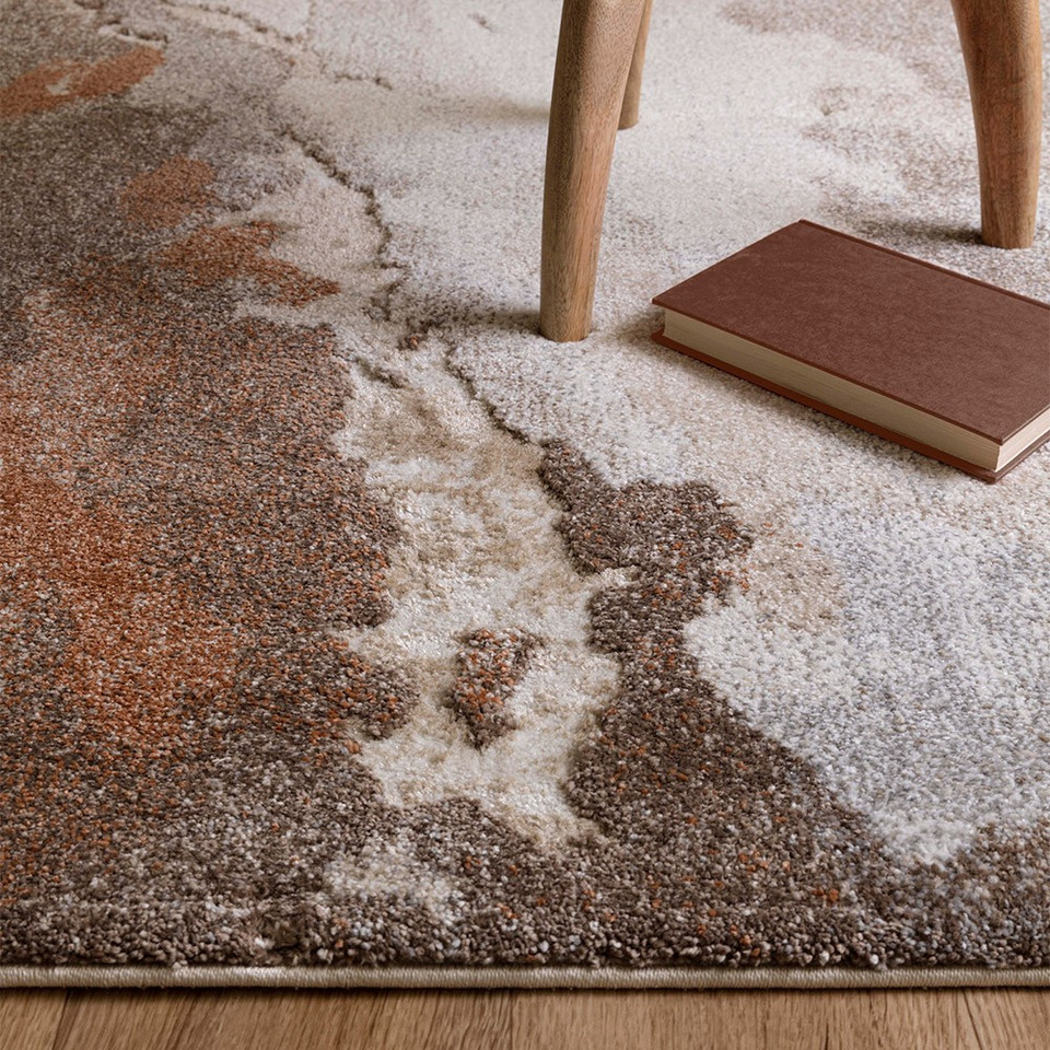 abstract terra shaggy rug side angle view with table legs and book