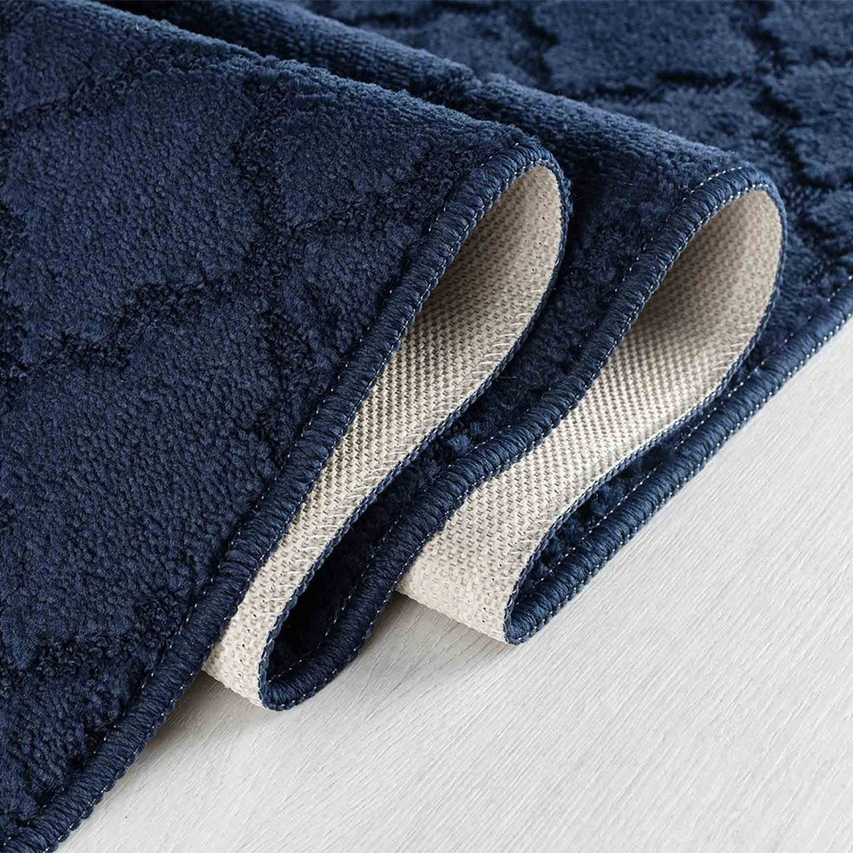 trellis navy doormat folded on wooden floor