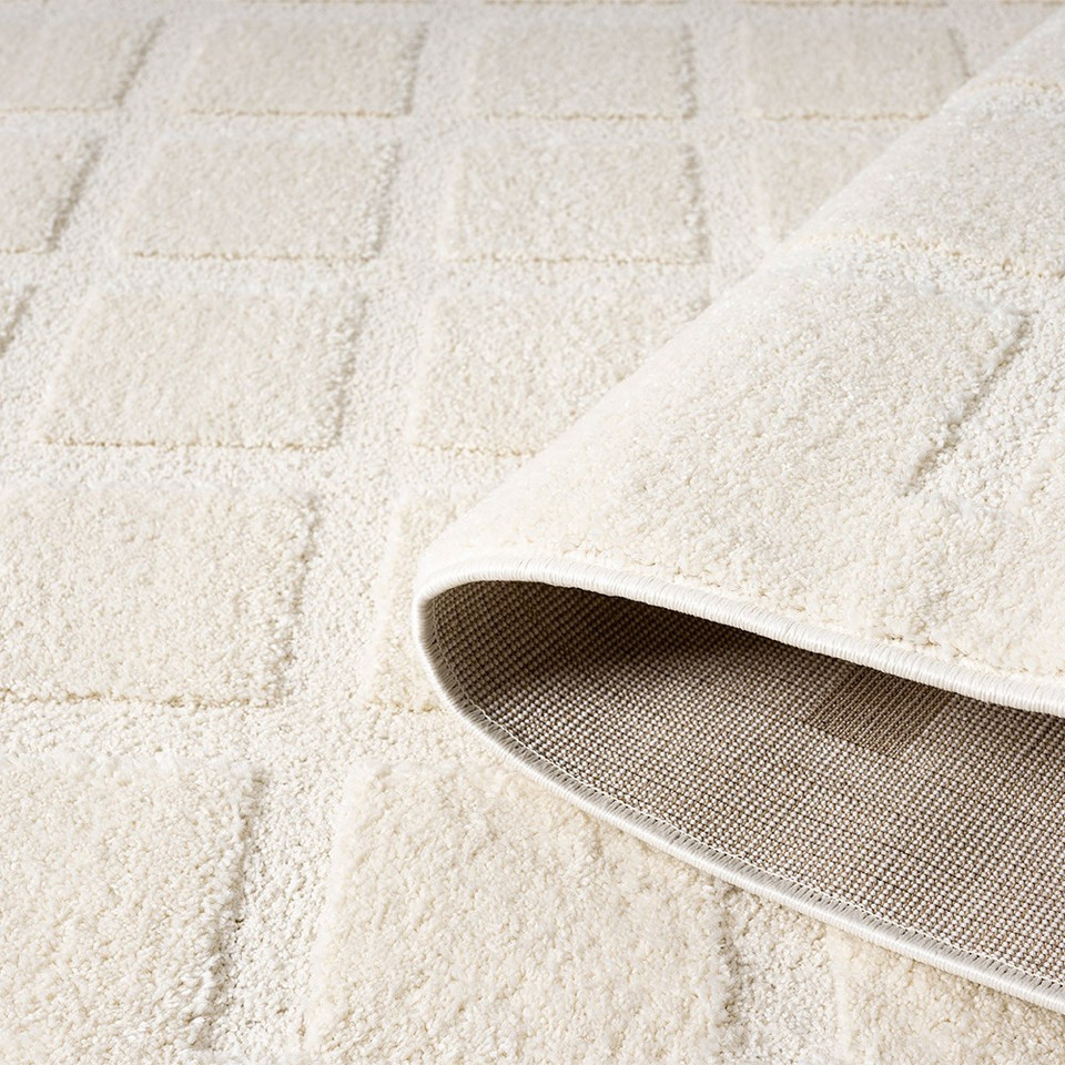 cross cream rug partially rolled