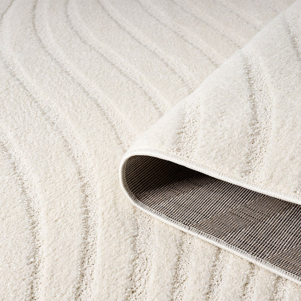 wave cream rug partially rolled