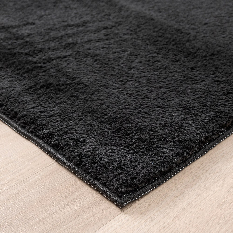 plain black rug runner side view of corner