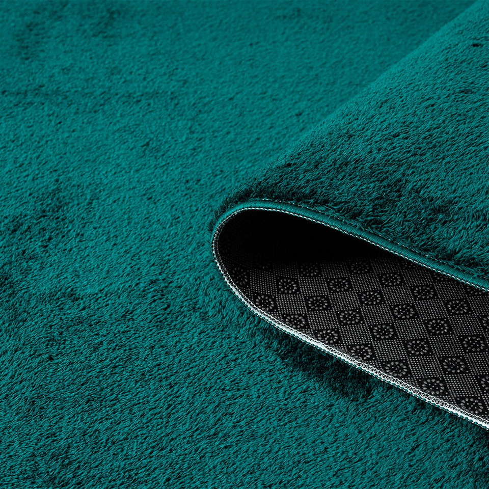 plain emerald rug runner partially rolled