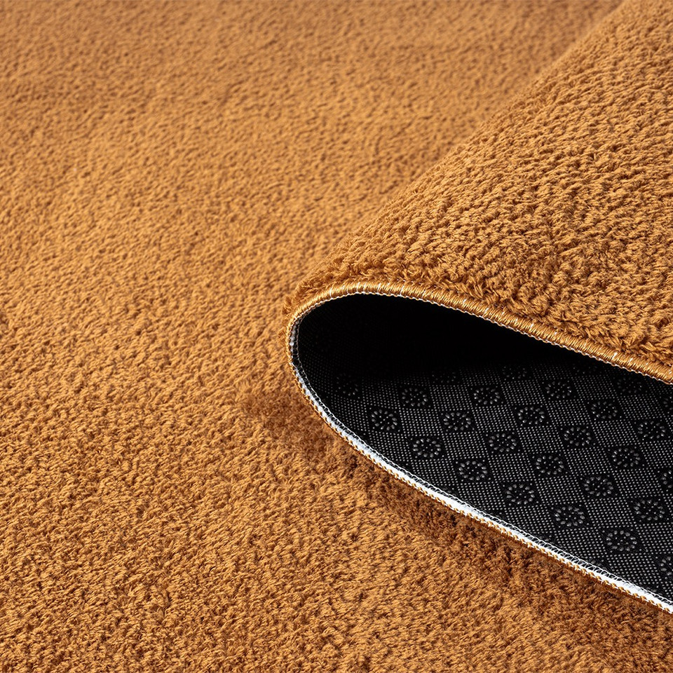 plain gold rug partially rolled