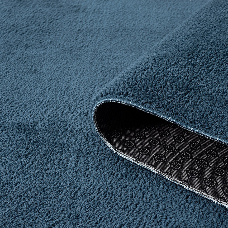 plain navy rug runner partially rolled