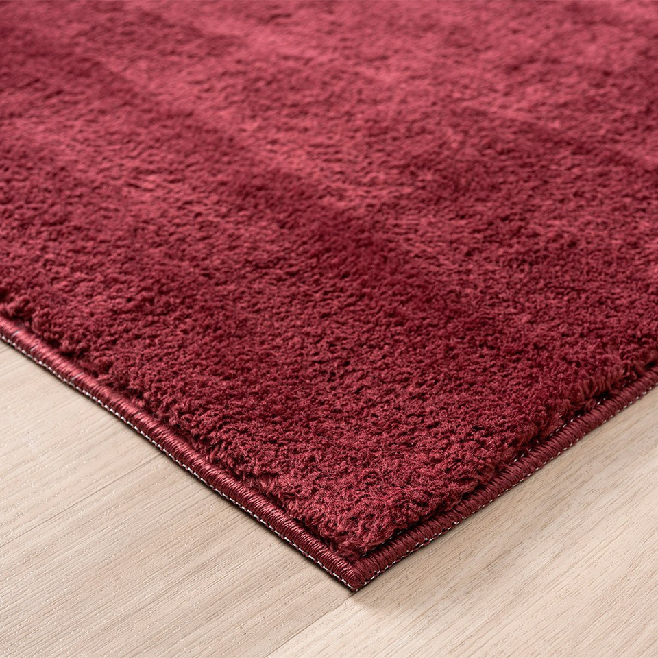 plain red rug side view of corner