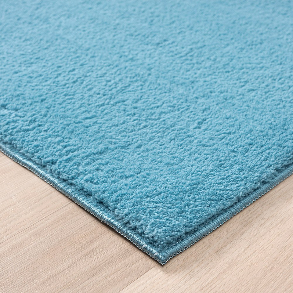 plain teal rug side view of corner