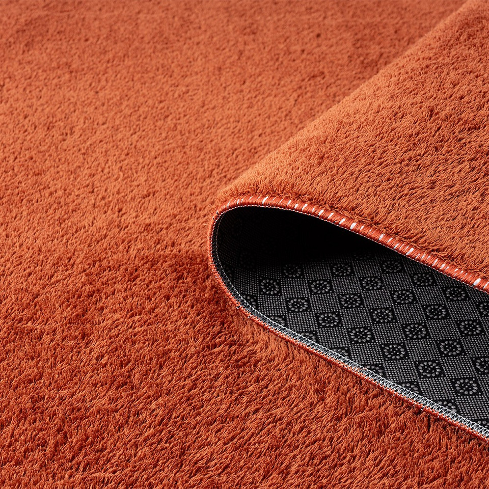 plain terracotta rug runner partially rolled