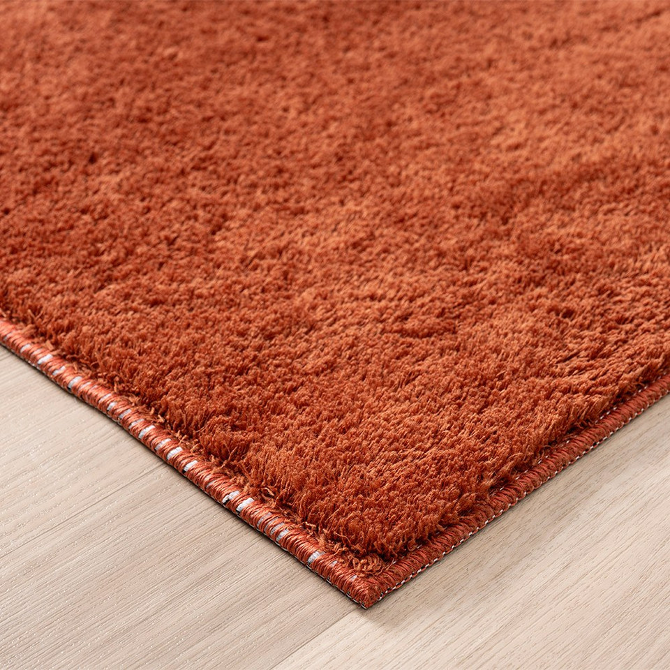 plain terracotta rug side view of corner