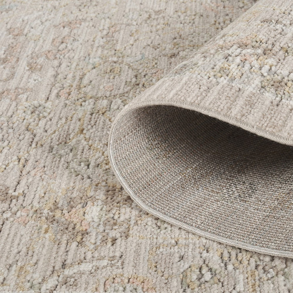 traditional floral beige rug closeup rolled