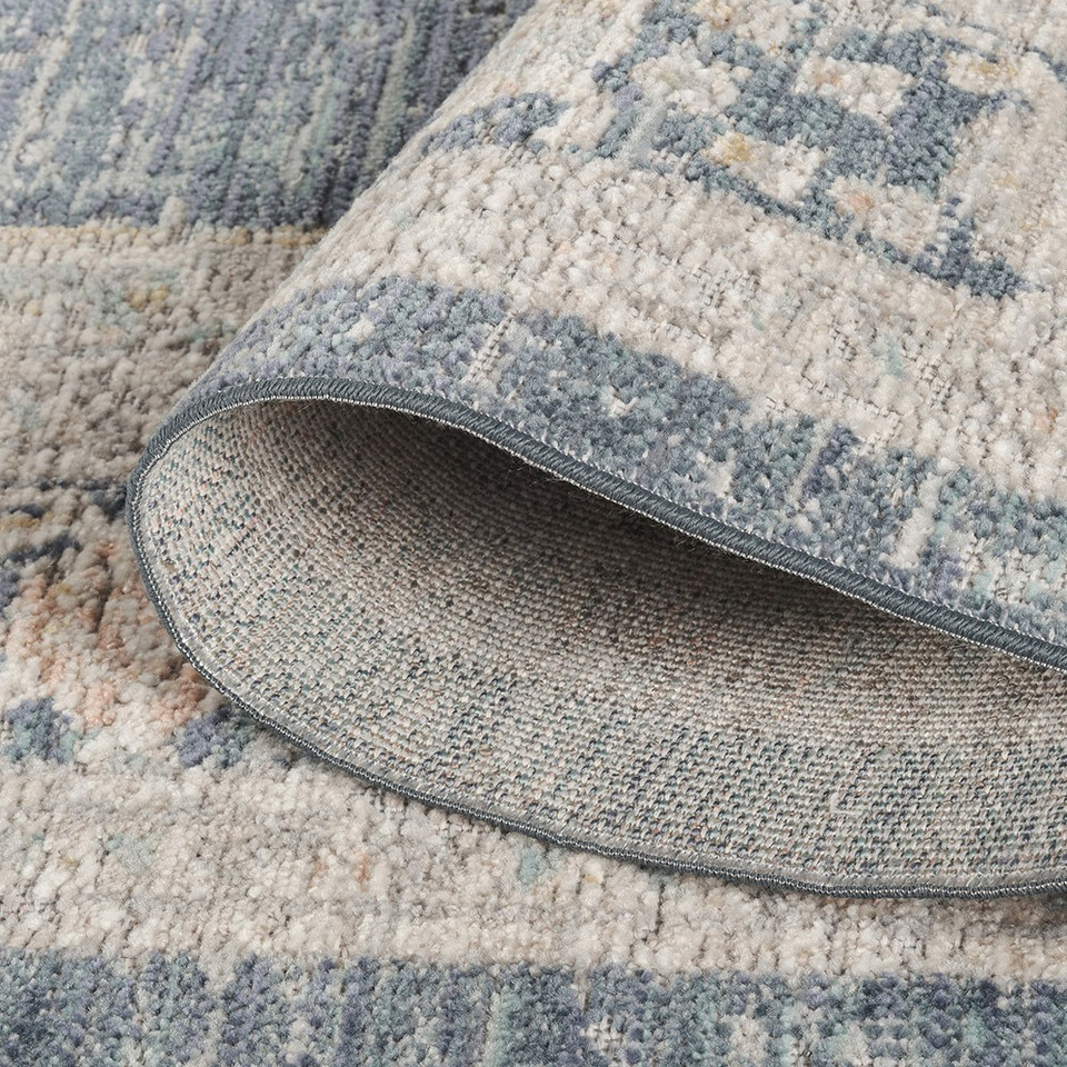 traditional floral navy rug closeup rolled