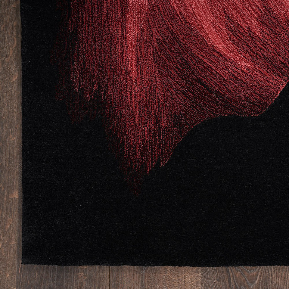 black abstract rug closeup corner on dark wood floor