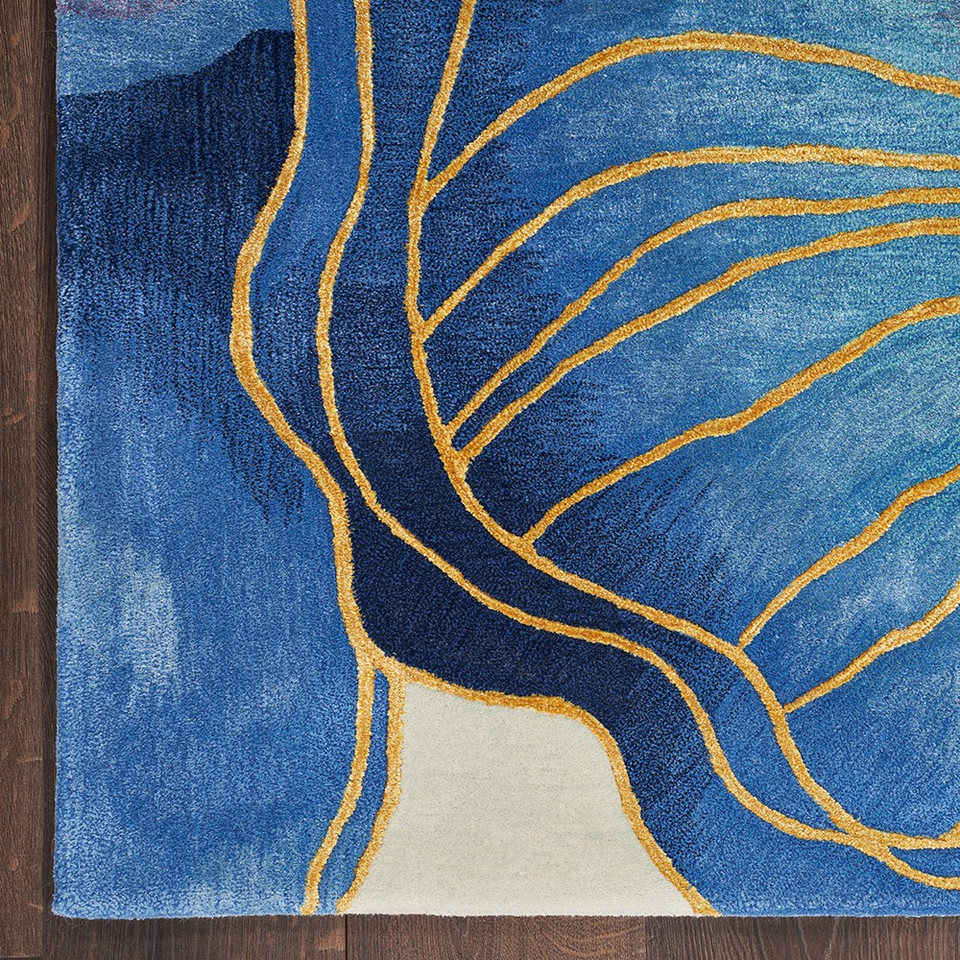 blue gold abstract rug closeup corner on dark wood floor