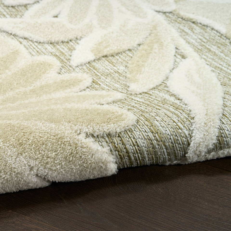 floral ivory sage rug closeup rolled on dark wood floor