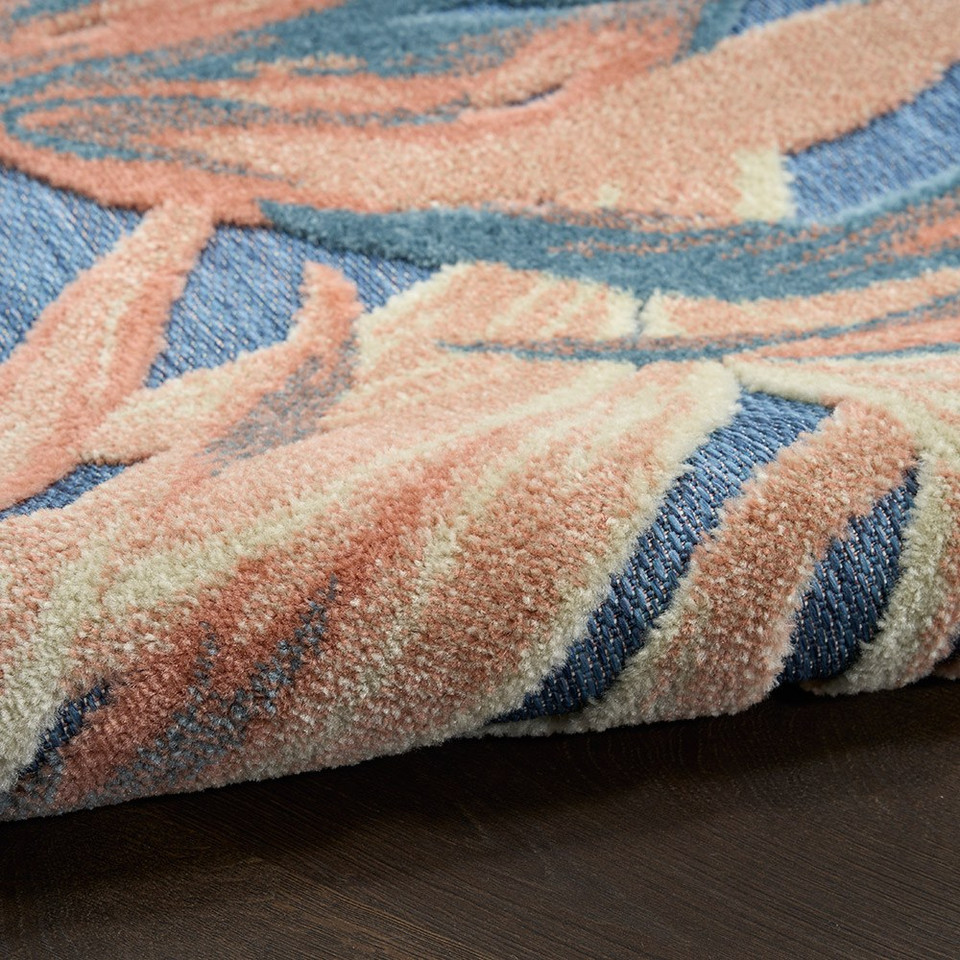 floral blue rose rug closeup rolled on dark wood floor