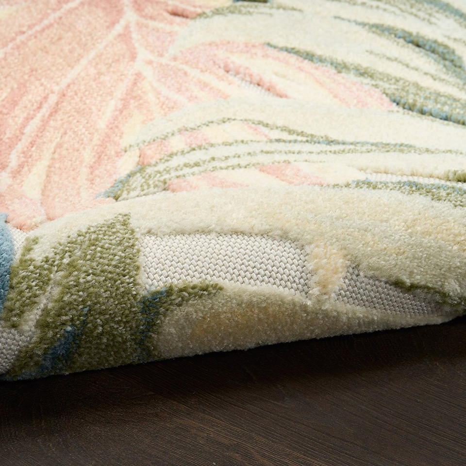 floral ivory green rug closeup rolled on dark wood floor