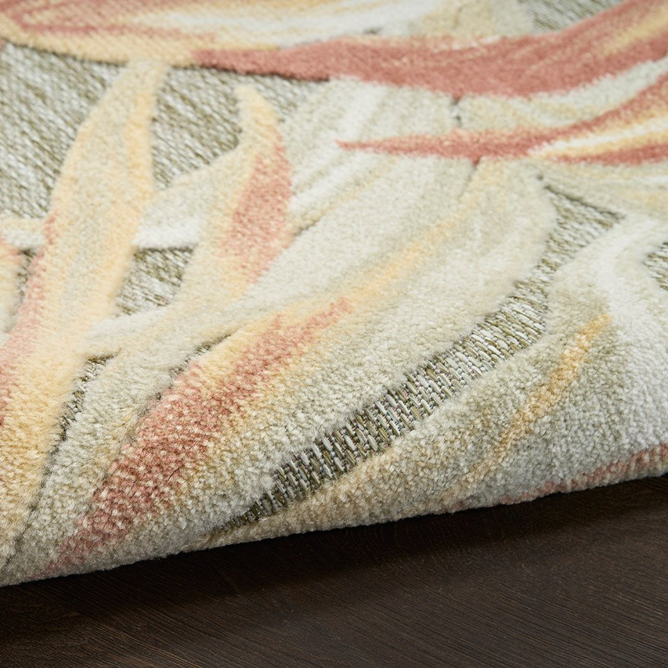 floral sage rose rug closeup rolled on dark wood floor