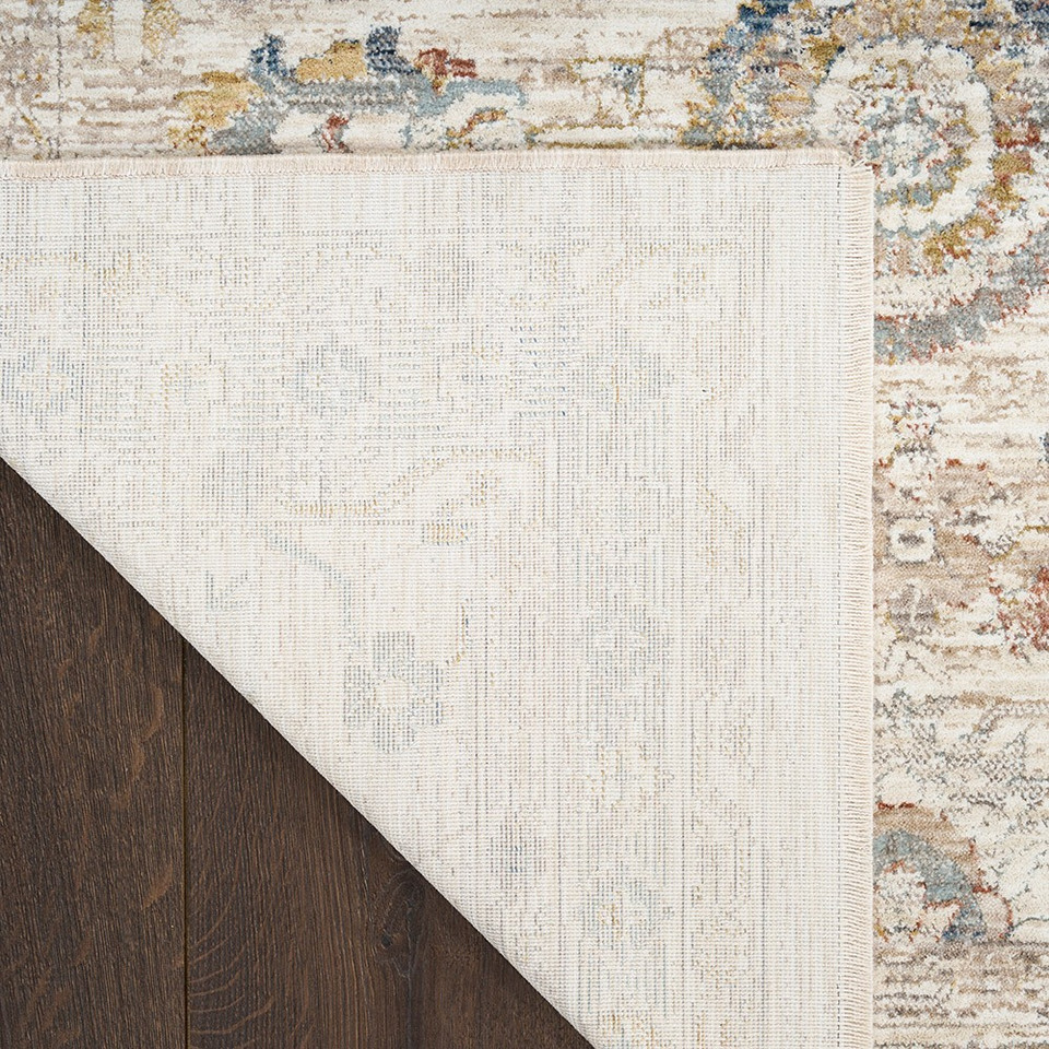 ivory multicolour traditional rug closeup corner fold on dark wood floor