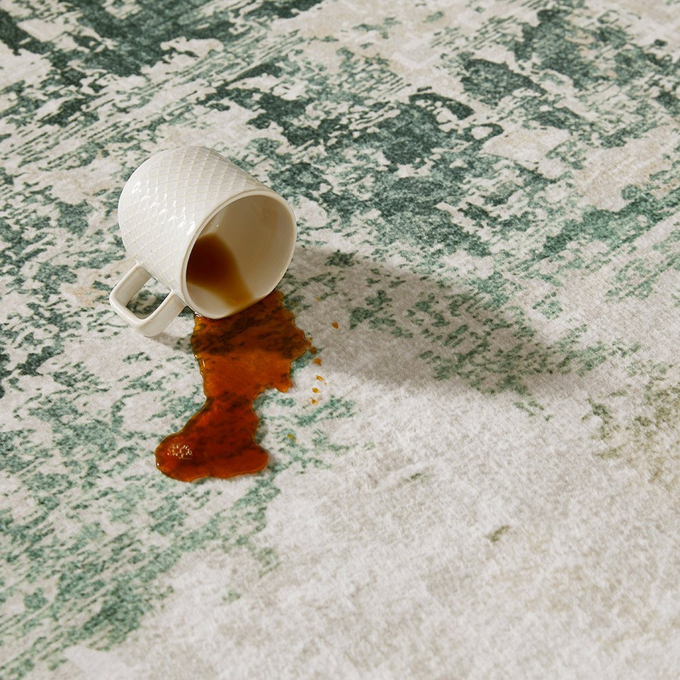 ivory olive abstract rug closeup with spilled drink