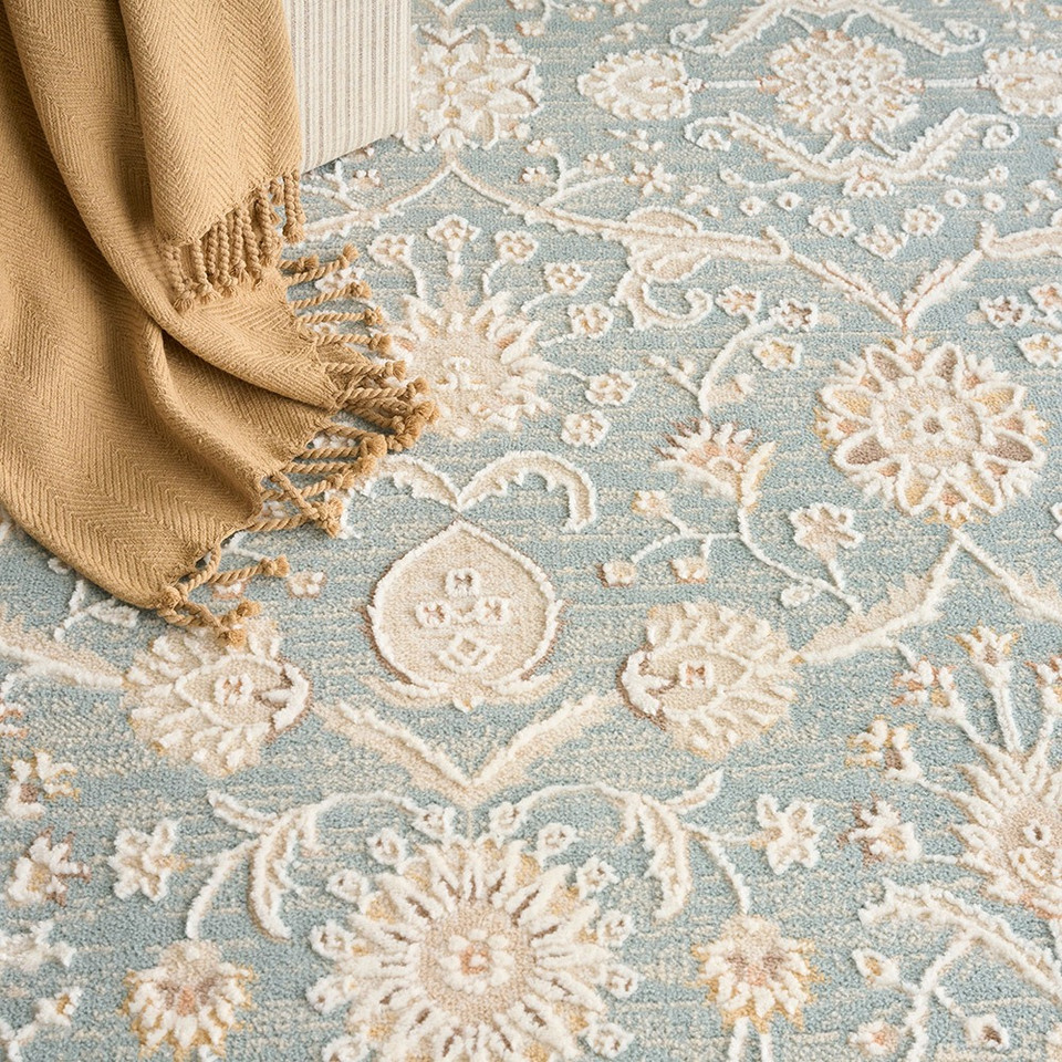blue traditional rug closeup with brown throw