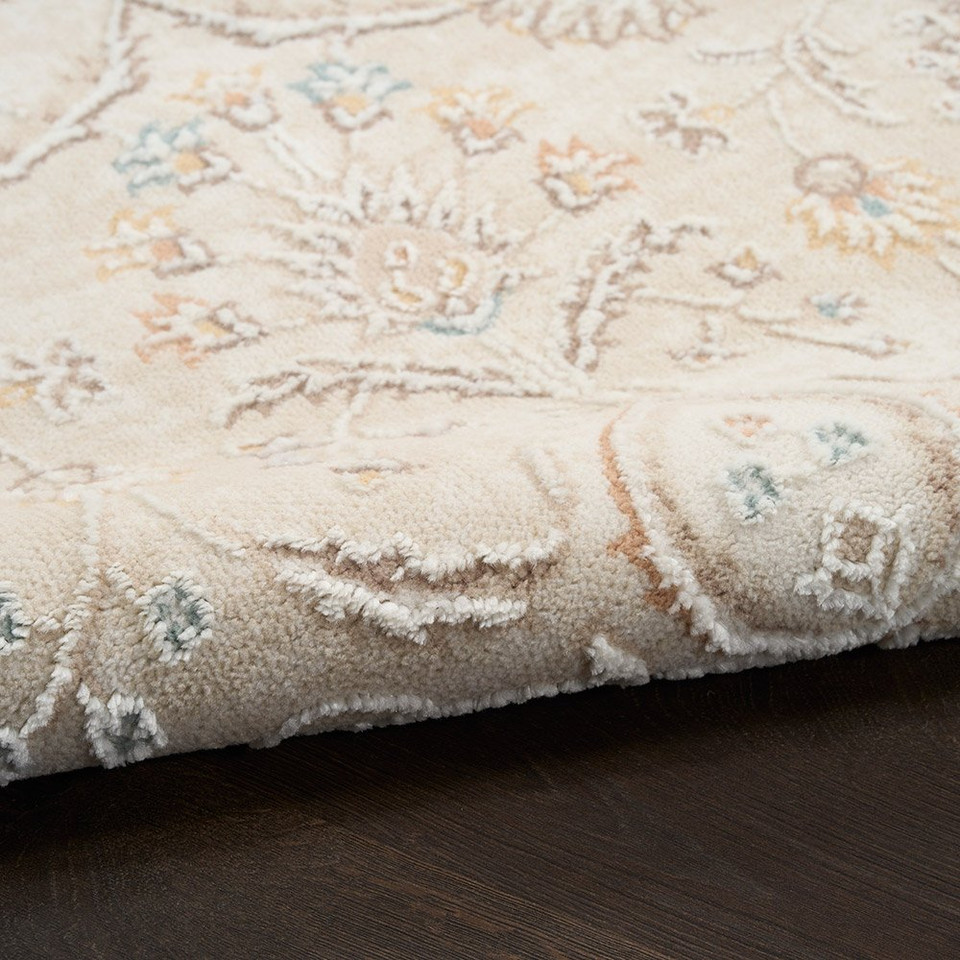 ivory traditional rug closeup rolled with dark wood floor
