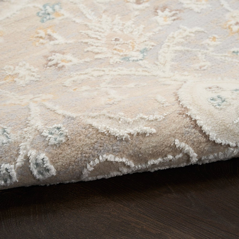 light grey traditional rug closeup rolled with dark wood floor