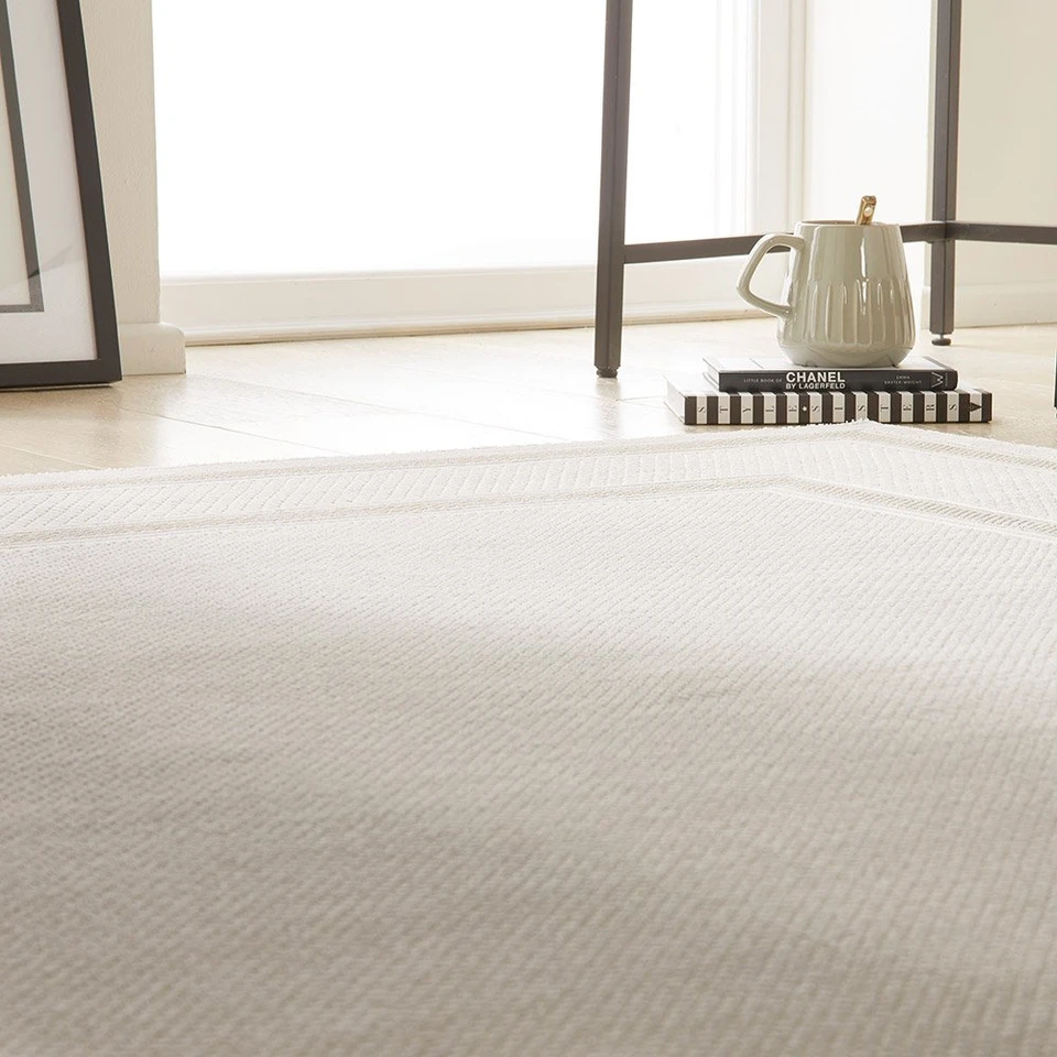 cream beige modern rug closeup living room with white decor