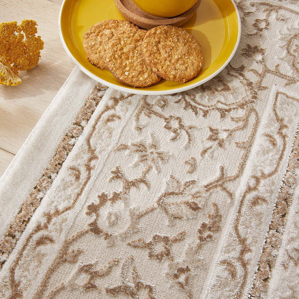 grey khaki traditional rug closeup edge with a plate of food