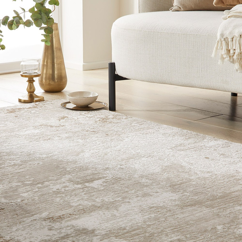 beige abstract rug in a living room with white decor