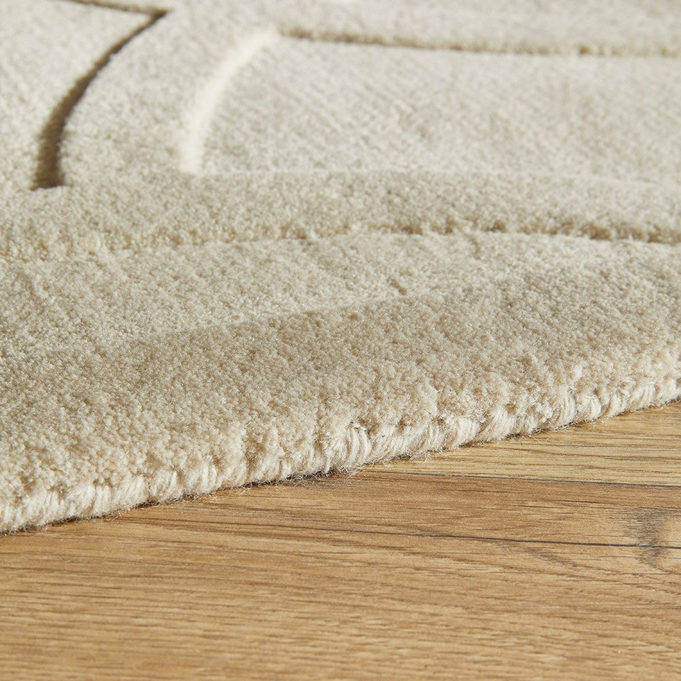 ivory wool rug closeup edge on wood floor