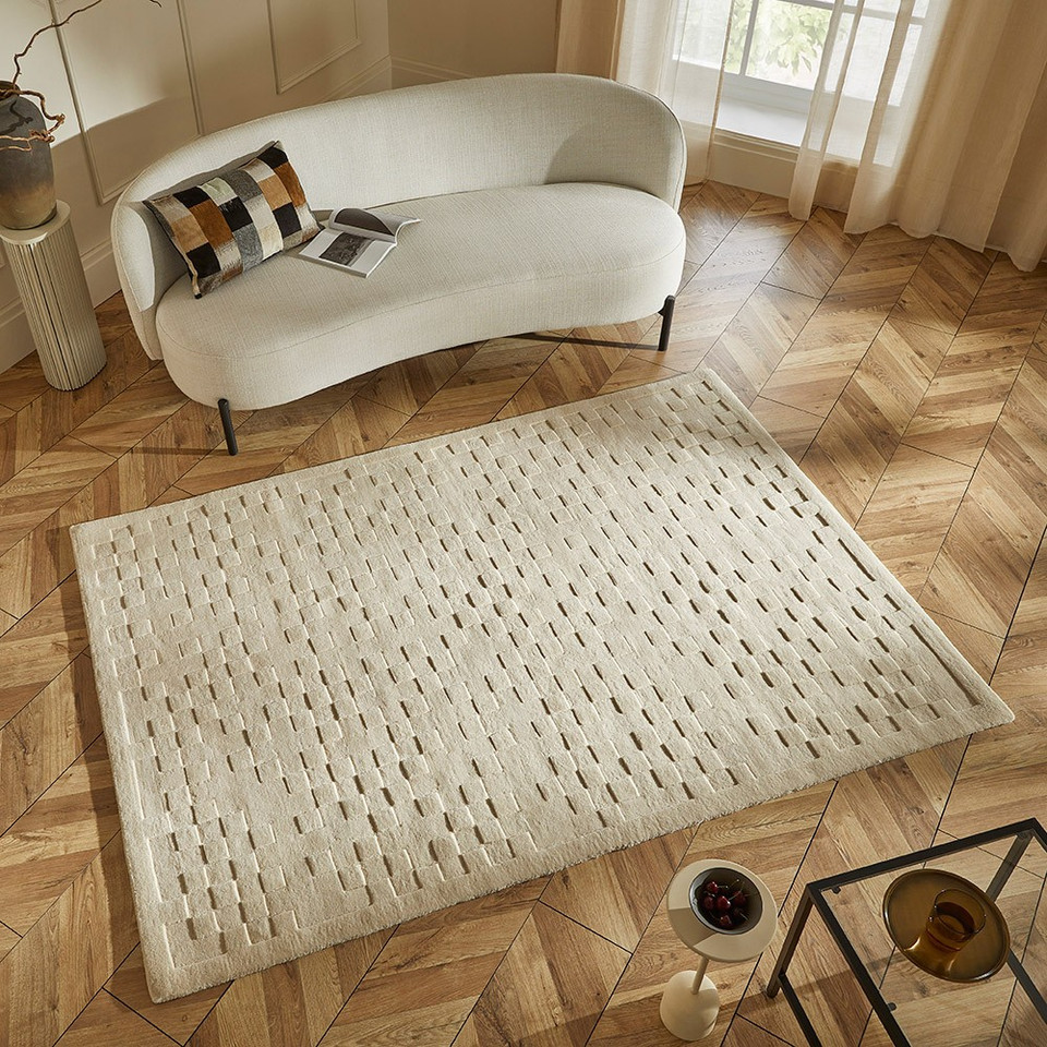 ivory wool rug in a living room with natural decor