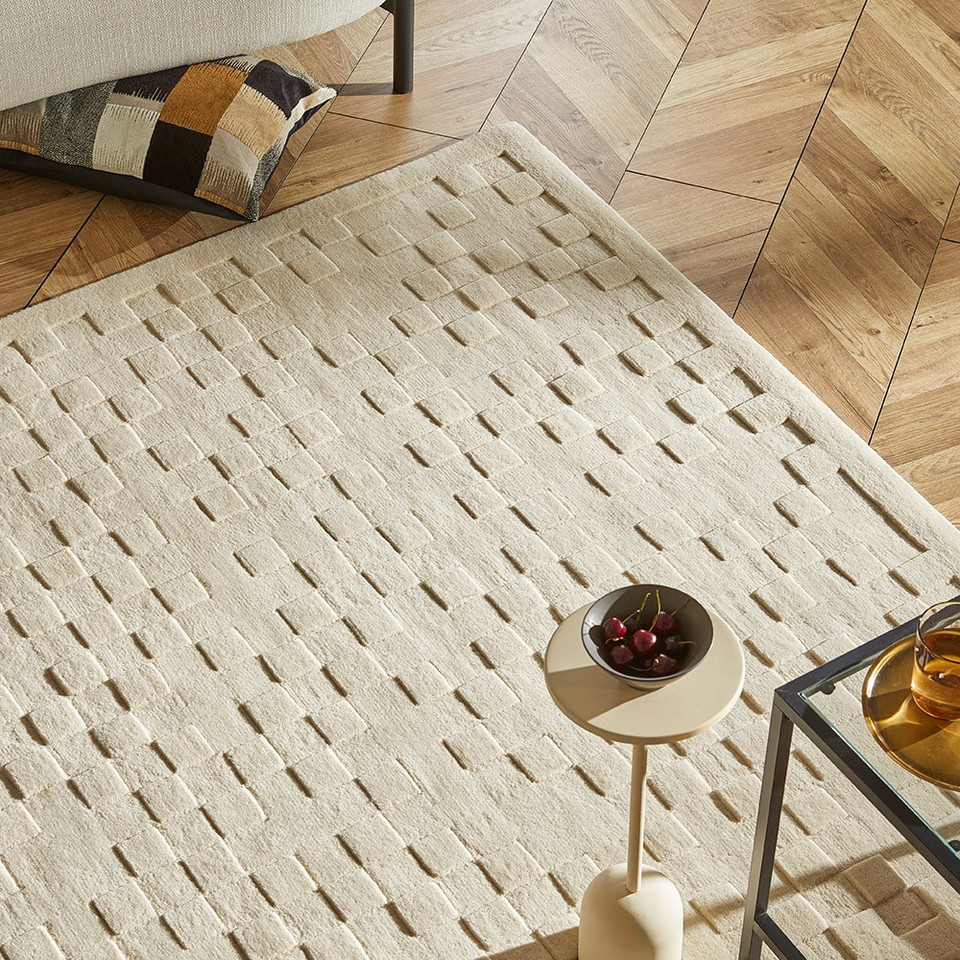 ivory wool rug in a living room with natural decor