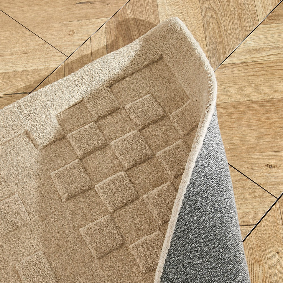 taupe wool rug closeup folded