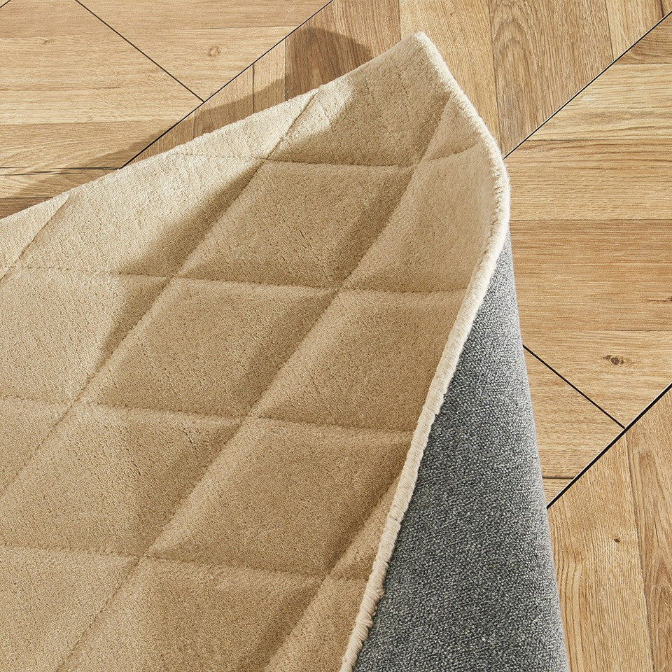 beige wool rug closeup folded