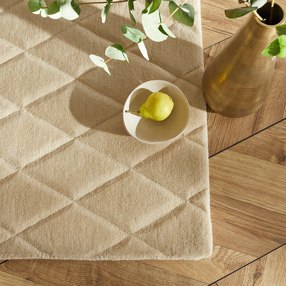 beige wool rug closeup corner with bowl of fruit