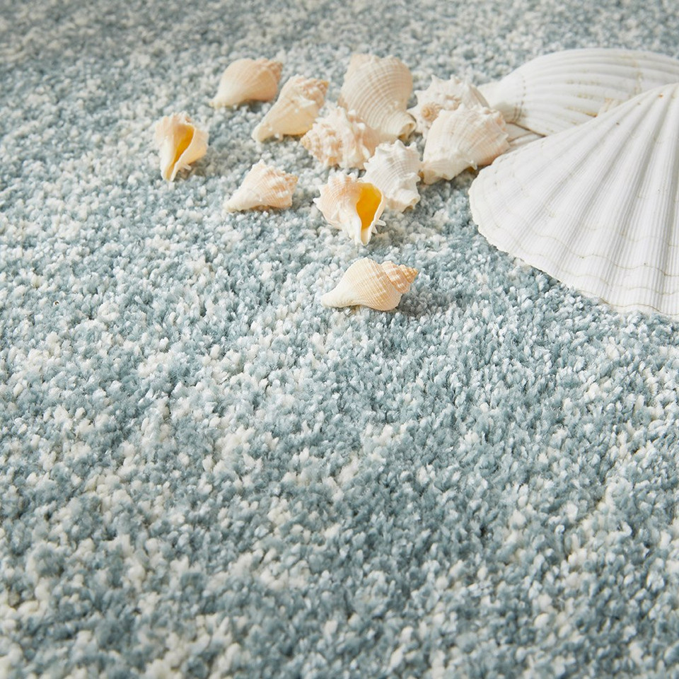 blue striped rug closeup with shells